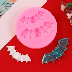 Detail view of pink Halloween bat silicone mold with white and blue molded samples