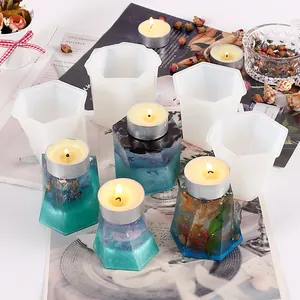 Detail view of geometric silicone molds and DIY resin candle holders with dried flowers.