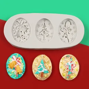 Detail view of Christmas silicone mold with finished bell and tree fondant decorations.