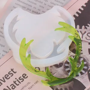 Detailed close-up view of reindeer antler silicone mold with green resin craft piece