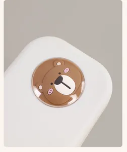 Detailed view of a cute 3D silicone bear decoration on a premium white stationery box lid