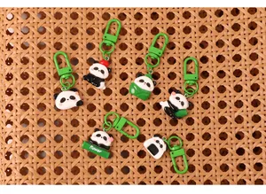 Detail view of cute cartoon panda resin keychains in various playful poses