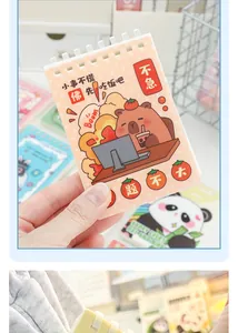Close-up of a cute capybara A7 spiral notebook with orange cover and portable design.