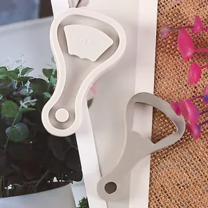 Macro detail view of a silicone beer bottle opener mold with a matching metal insert.