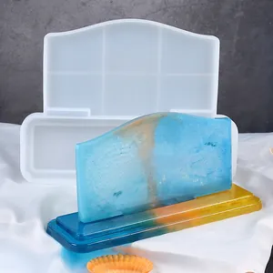 Detailed view of DIY crystal resin mold and finished ocean-themed decorative plaque