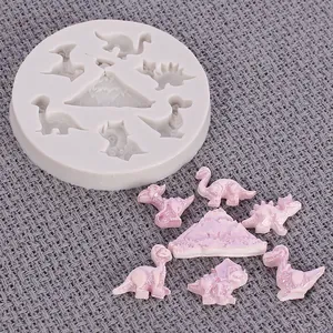 Close-up of dinosaur silicone mold with corresponding purple resin dinosaur figures.