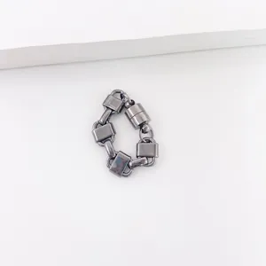 Close-up of gunmetal chain link magnetic ear cuff with industrial minimalist design