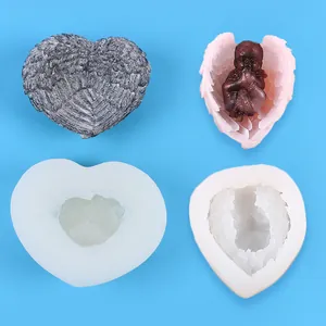 Detailed macro view of heart-shaped winged silicone molds with finished resin art samples