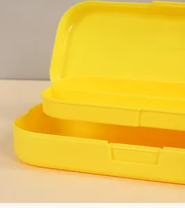 Close-up detail of a bright yellow double-layer plastic stationery box with tray