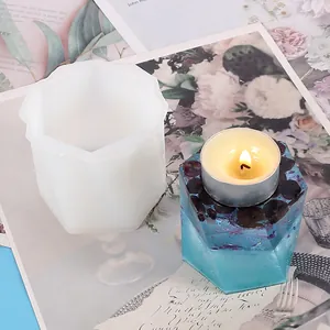 Detailed view of DIY silicone mold and finished blue resin hexagonal candle holder