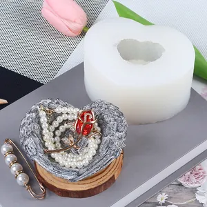 Detailed view of heart silicone mold alongside finished resin craft with pearls and rose
