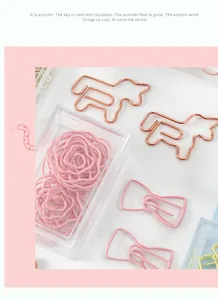 Close-up of cute dog and flower shaped metal paper clips in pink and rose gold finish