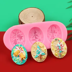 Detailed view of pink Christmas silicone mold with finished tree and bell decorations