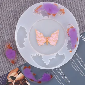 Detail view of irregular silicone coaster mold with finished resin butterfly piece