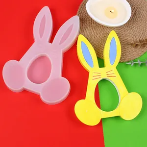 Detail of bunny silicone mold and finished yellow Easter candle holder ornament.