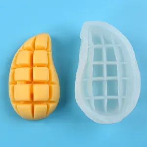 Detalle de un molde de silicona con forma de mango y vela de fruta amarilla casera
