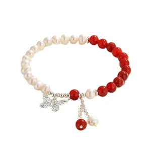 Freshwater pearl and red agate beaded bracelet with a decorative silver butterfly pendant