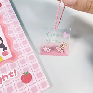 Gros plan d'un porte-clés en acrylique rose pailleté avec de mignons dessins de dessins animés.