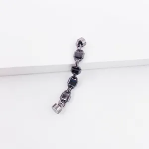 Detailed macro view of gunmetal chain earring with lock charms and magnetic clasp
