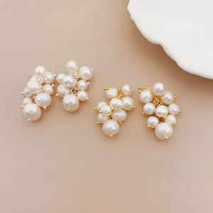 Detailed view of elegant freshwater pearl grape cluster stud earrings in gold and silver
