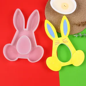 Silicone mold for Easter bunny candle holder alongside a finished yellow decorative rabbit