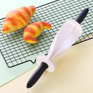 Professional plastic croissant dough cutter roller with black handles on cooling rack