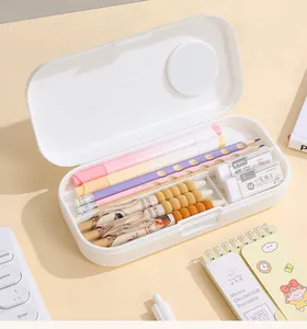 Close-up view of open white double-layer pencil case with organized pens and erasers