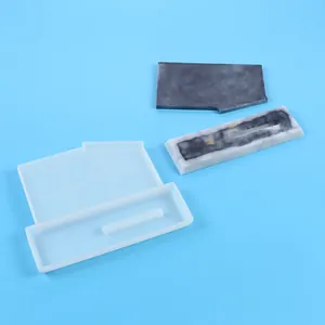 Detailed view of DIY silicone mold set with finished marble-textured resin pieces
