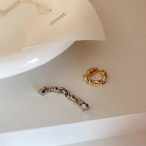 Detailed macro view of gold and silver magnetic chain link ear cuffs for non-pierced ears