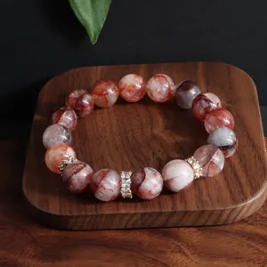 Nahaufnahme eines roten Hämatoid-Quarz-Armbands mit zirkonia-besetzten Zwischenstücken