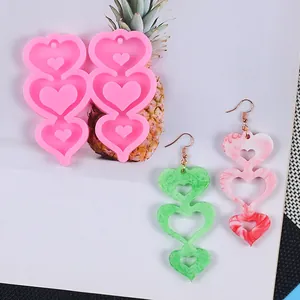 Silicone mold for DIY heart earrings and finished marbled resin jewelry accessories