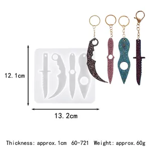 Detail view of silicone mold with four different knife and claw shapes for DIY resin keychains