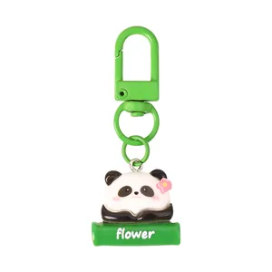 Cute cartoon panda resin keychain featuring a green clasp and floral bamboo base design