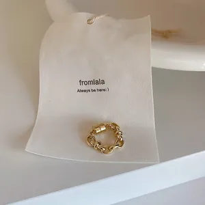 Detailed view of a gold chain-link magnetic ear cuff displayed on a white minimalist tag