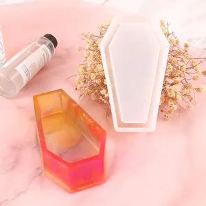 Detailed view of DIY coffin-shaped silicone resin mold with a colorful finished sample