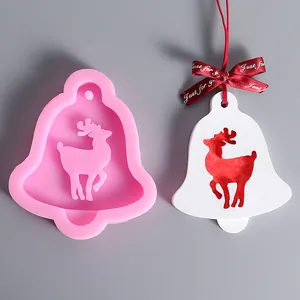 Detailed view of bell-shaped reindeer silicone mold with finished white plaster craft