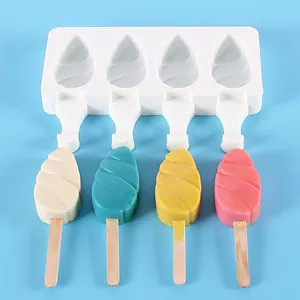 Four-cavity white silicone popsicle mold with colorful spiral DIY ice creams on blue background