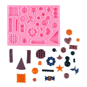 Molde de silicona rosa con múltiples formas para hacer mini dulces y galletas DIY