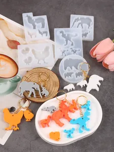 Detail view of animal silicone molds showing elephant and dinosaur shapes with resin tags