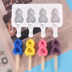 Close-up of a 4-cavity silicone ice pop mold with colorful heart-shaped popsicles