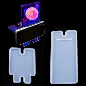 Detailed view of translucent silicone molds and finished resin phone stand project