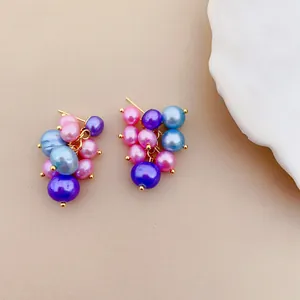 Detailed close-up of colorful freshwater pearl cluster earrings in grape style