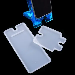 Detailed view of DIY epoxy resin phone stand silicone molds and finished blue resin stand