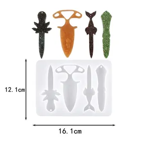 Detailed view of DIY silicone resin mold with finished dagger-shaped keychain samples