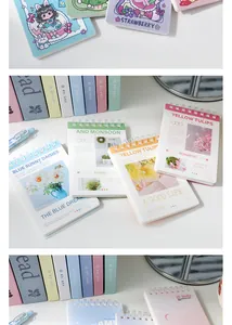 Close-up view of cute A7 spiral notebooks featuring diverse floral and cartoon cover designs.
