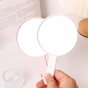 Minimalist portable round handheld makeup mirror for daily vanity and travel use