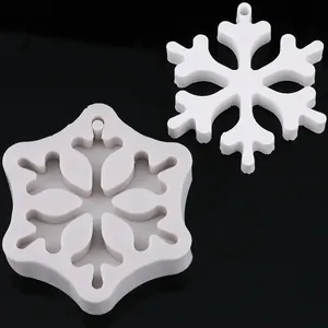 Close-up of white snowflake silicone mold with a finished decorative ornament piece