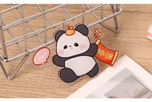 Close-up of a cute cartoon acrylic panda fridge magnet with decorative get rich scroll