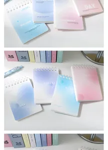 Close-up of A7 spiral notebooks with pastel gradient covers and inspirational English text