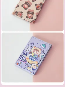 Close-up of cute cartoon bear and astronaut patterns on folding makeup mirrors